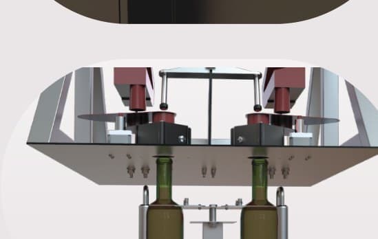 The corking head lowered over two bottles held in their supports.