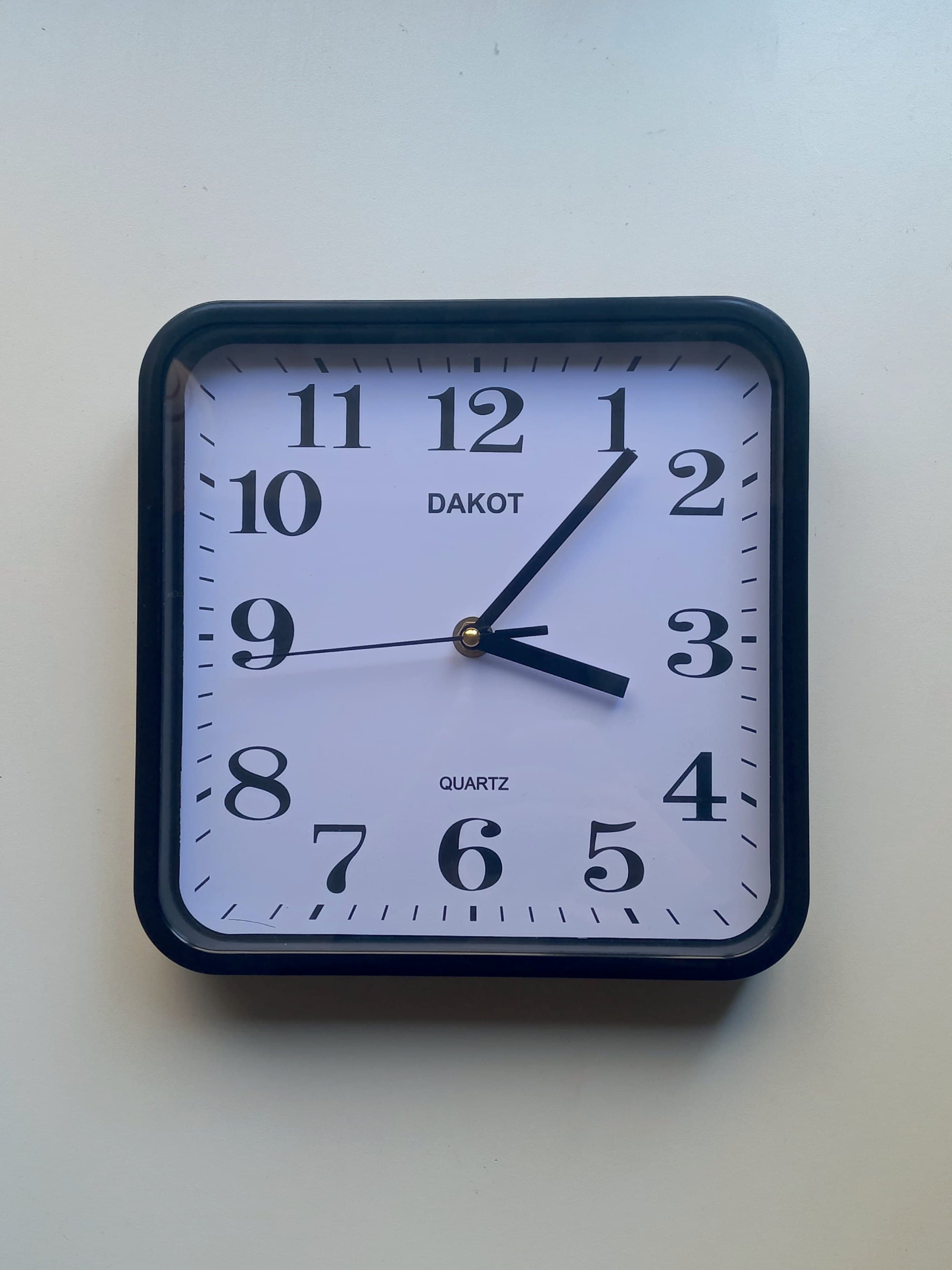 The original Dakot clock at an angle, showing the dark blue bezel and the domed glass.