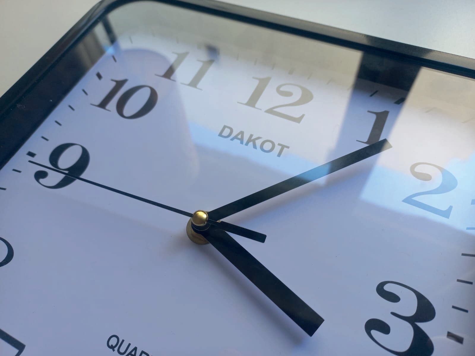 Close-up of the original dial with the hands and the Dakot logo printed on it.