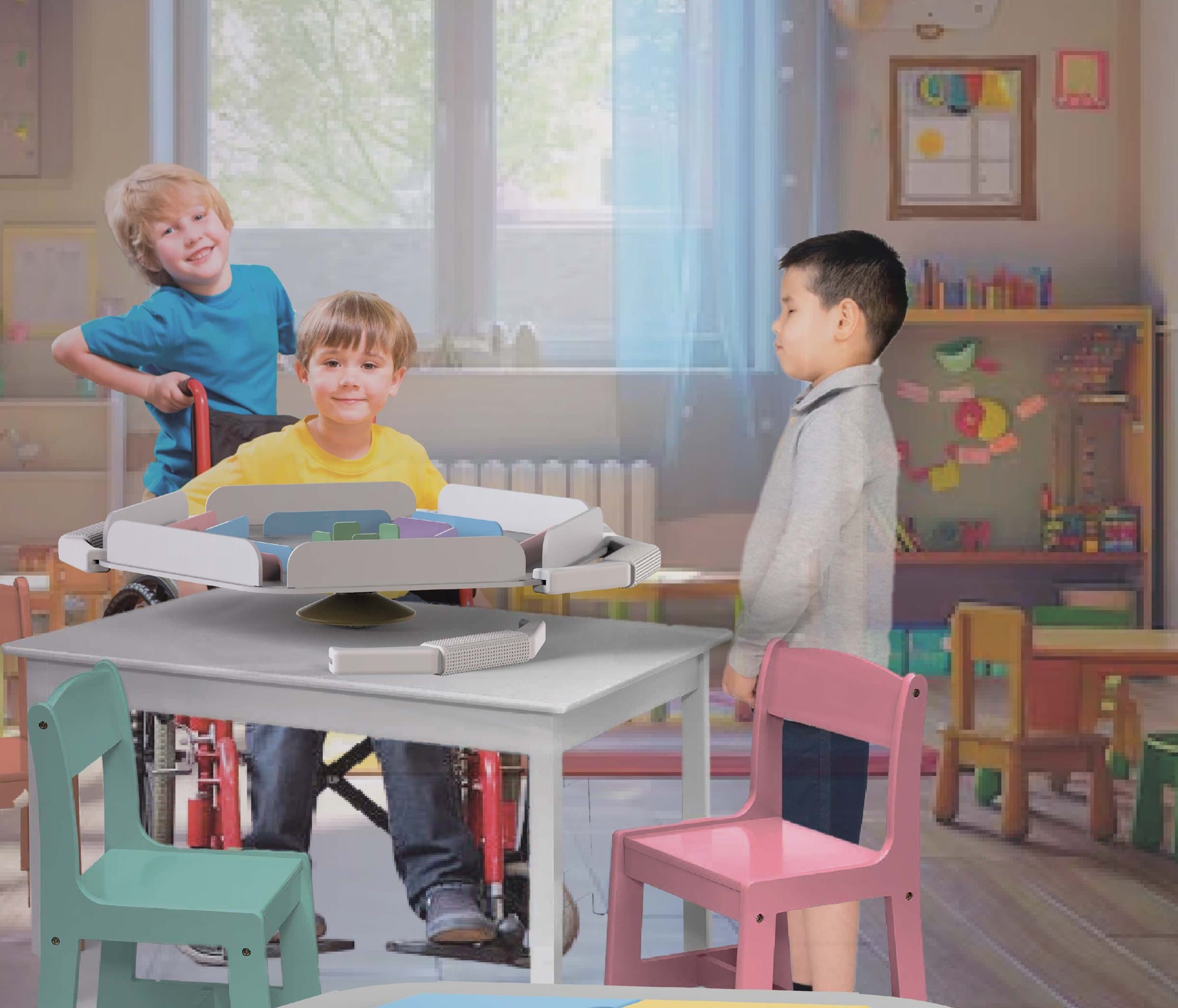 Three children around a classroom table with the jugaremos board on it; one of them plays from a wheelchair.
